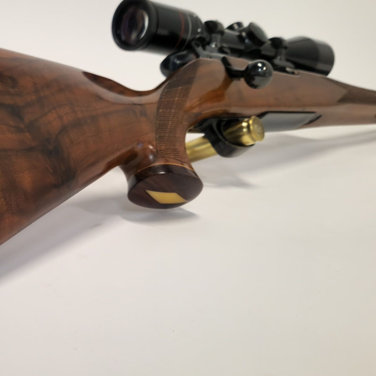 Wooden rifle with scope on a white background