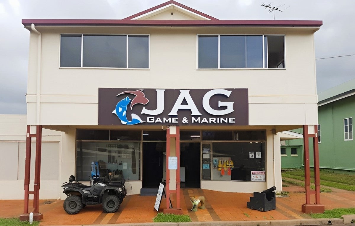 Two-story building with 'JAG Game & Marine' sign and an ATV parked in front.